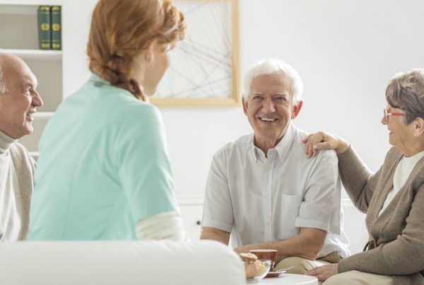 Seniors sitting with nurse