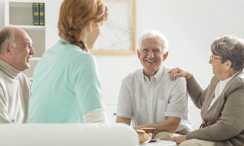 Seniors sitting with nurse